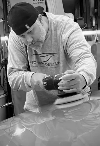 man detailing and polishing a car