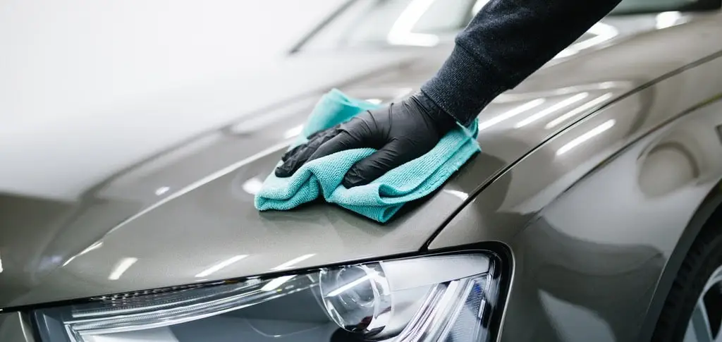 wiping a detailed car with a microfiber towel