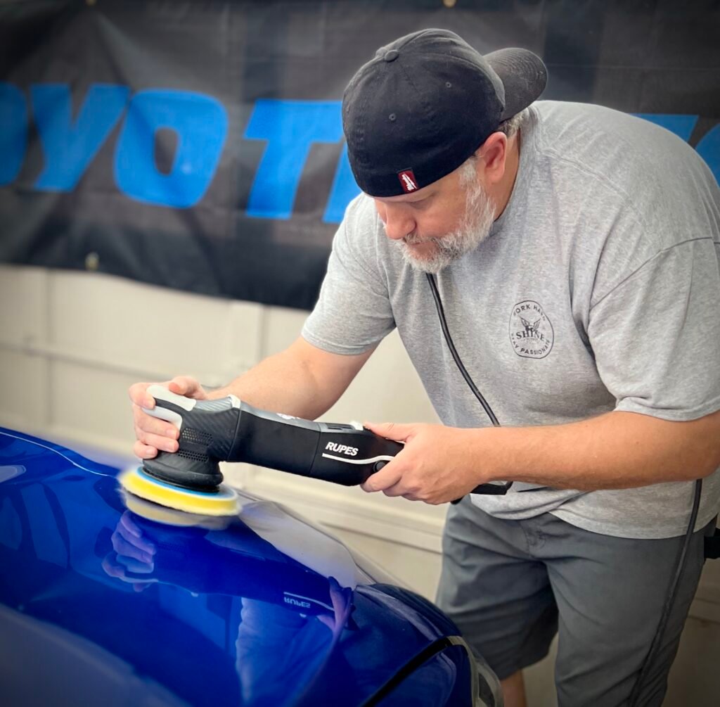 a man polishing, buffing, waxing. and paint correction