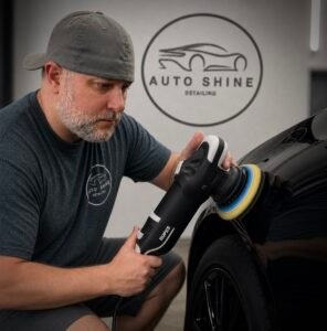 the owner of auto shine detailing paint correcting a vehicle.